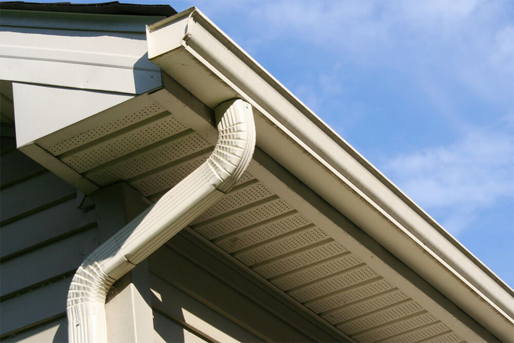 view of a gutter and drain on the side of a house