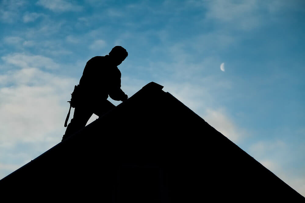 worker on a rooftop early in the morning