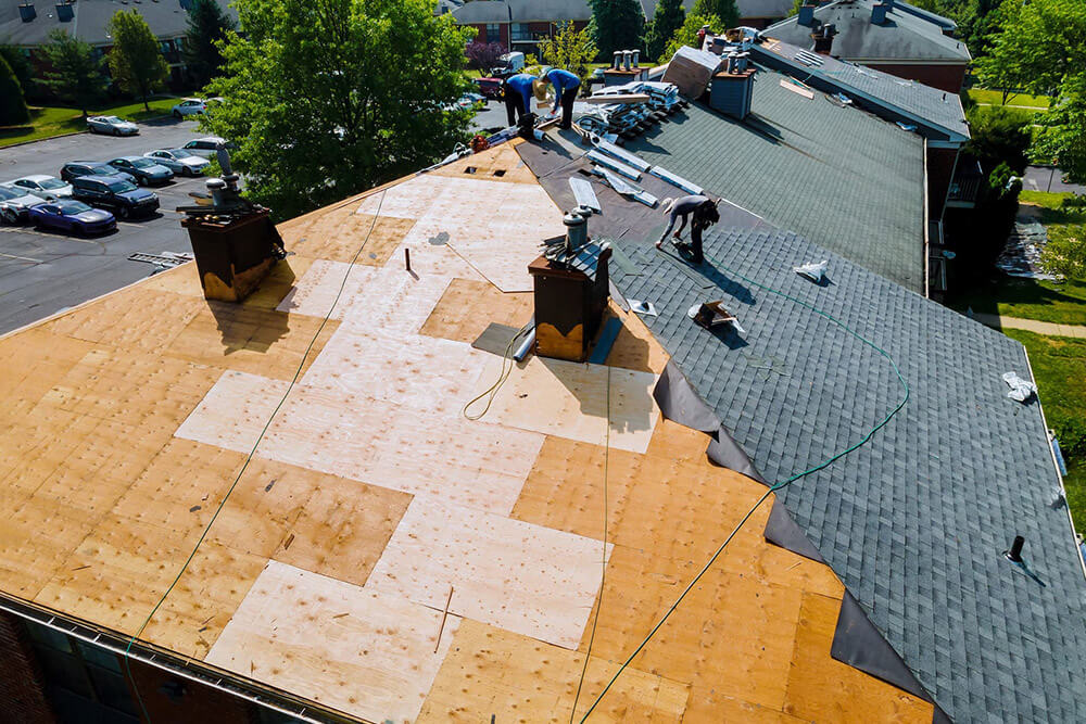 contractors installing a new roof on a house