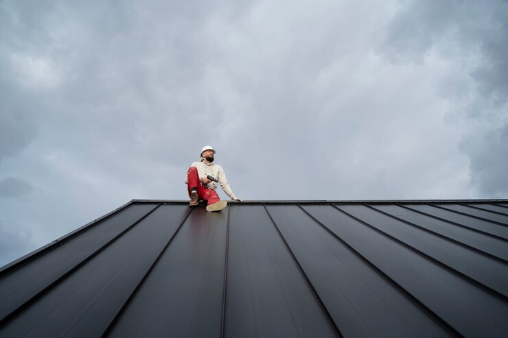 Full shot of roofer working with helmet